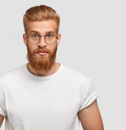 confident-ginger-man-with-trendy-hairstyle-wears-spectacles-looks-directly 1-1